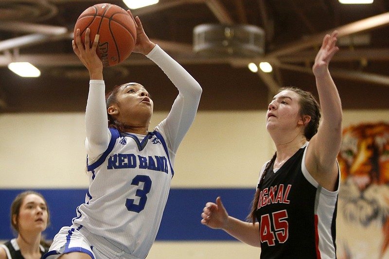 Red Bank's Savannah Washington drives to the basket against Signal Mountain's Olivia Koontz during a Best of Preps tournament semifinal Jan. 3 at Chattanooga State. / Staff photo by C.B. Schmelter