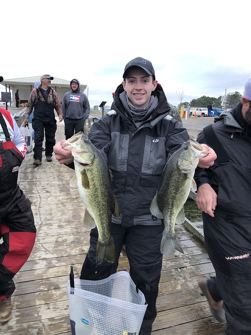 Lee University graduate student Ben Fouts shows off two of the five bass that made him the winning co-angler in the BFL Choo Choo Division tournament last Saturday on Lake Guntersville. / Contributed photo