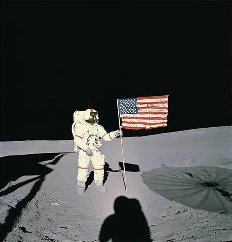 In this image provided by NASA, astronaut Alan B. Shepard stands with the American flag on lunar surface in February 1971. Shepard was the first American to fly in space and the fifth human to walk on the moon. This particular mission was Apollo 14 which launched Jan. 31, 1971, and returned Feb. 9, 1971 after having spent 33 1/2 hours on the surface. (AP Photo/NASA)