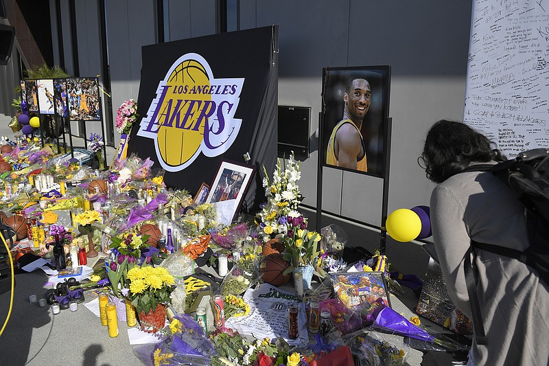 AP photo by Mark J. Terrill / Fans look at a memorial to former Los Angeles Lakers player Kobe Bryant at the NBA team's practice facility on Jan. 29 in El Segundo, Calif.