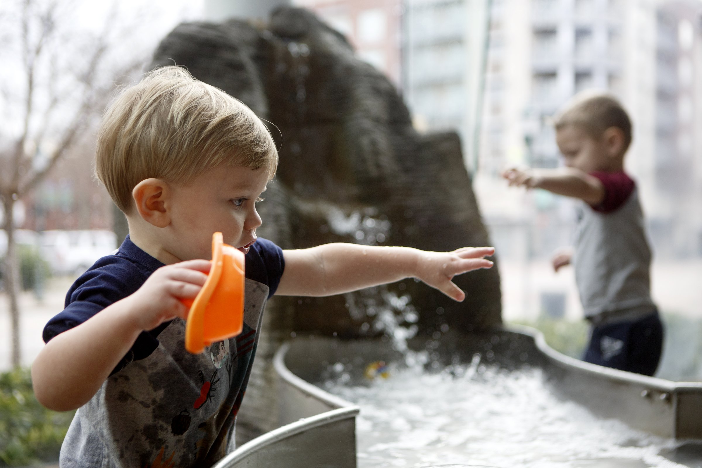 Staff photo by C.B. Schmelter / One-year-old Mason Johnson, left, plays in the water at the RiverPlay exhibit at the Creative Discovery Museum on Wednesday, Jan. 29, 2020 in Chattanooga, Tenn.