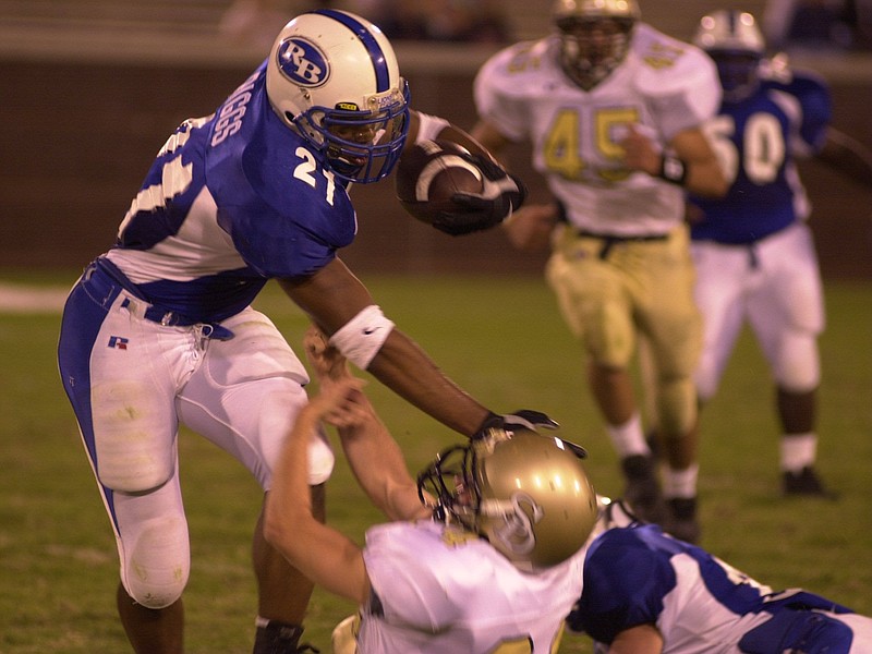 Red Bank running back Gerald Riggs Jr., who went on to play at Tennessee, stiff-arms Soddy Daisy's Brad Jaquith during a high school game at Finley Stadium. Riggs was rated the No. 7 prospect nationally in the recruiting class of 2002 in the 247Sports.com composite rankings. / Staff file photo