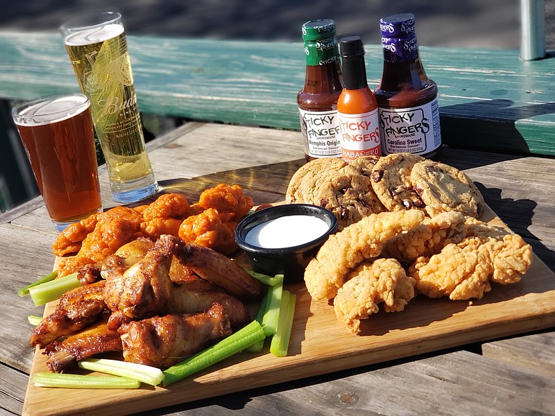 Photo from Little Dog Agency / The Big Cluckin' Deal at Sticky Fingers on Super Bowl Sunday includes 24 boneless wings, 24 chicken fingers, 24 smoked wings and 12 cookies, priced at $60. Get double the portions for $119.