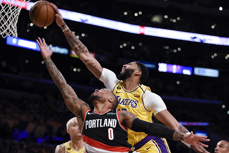Los Angeles Lakers forward Anthony Davis blocks a shot by Portland Trail Blazers guard Damian Lillard during the first half of Friday night's game in Los Angeles. / AP photo by Kelvin Kuo