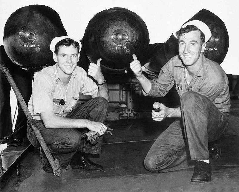 Torpedoes and depth charges carried by destroyers of the United States fleet, display a personal touch” these days. These torpedo warheads carry the names of Japanese aircraft carries and battleships shown Feb. 3, 1942. (AP Photo)