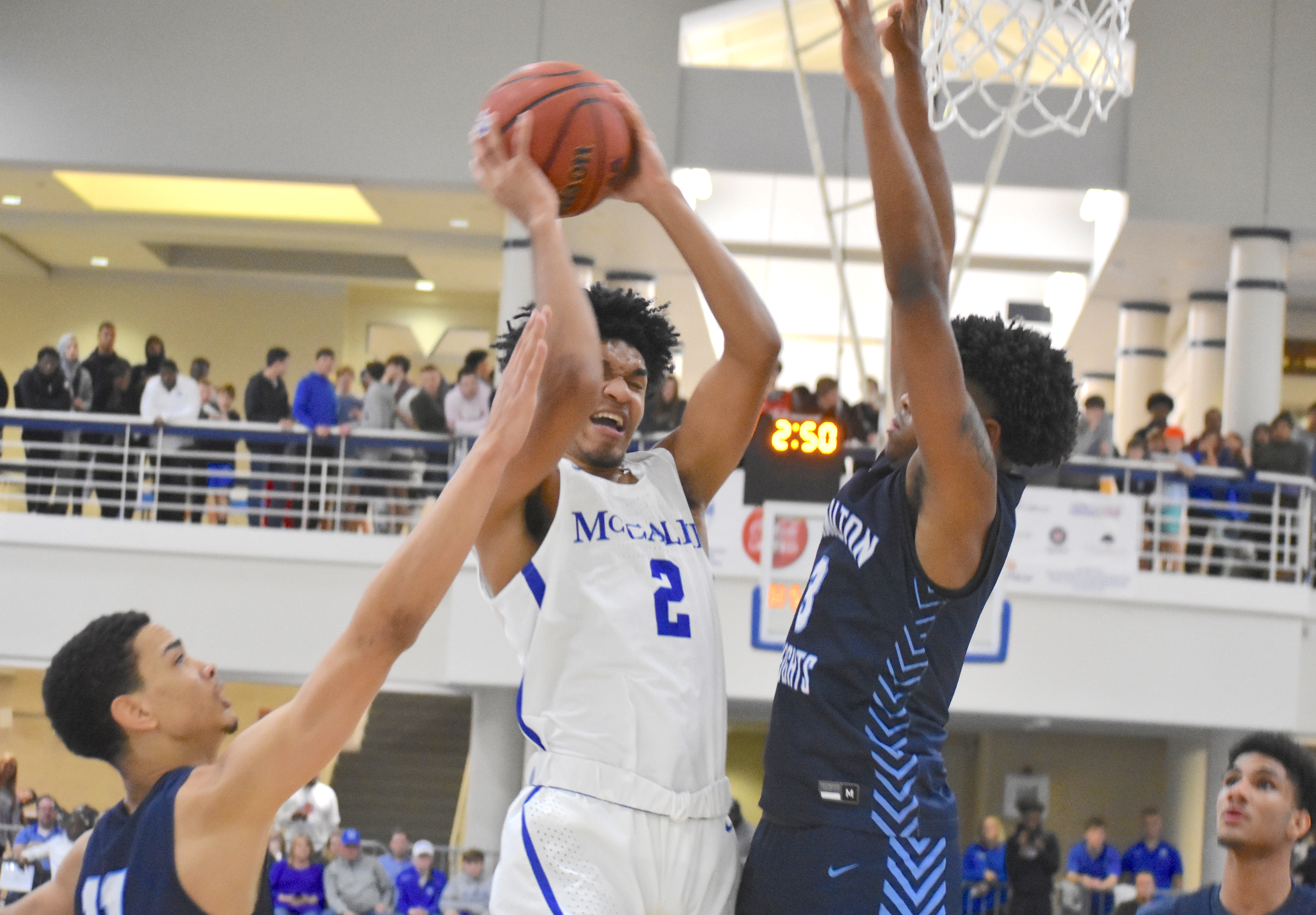 McCallie junior guard Joryam Saizonou finishes at the hoop against Hamilton Heights defenders. Saizonou scored 13 points in a 67-52 loss to the Hawks in the Dr Pepper Classic on Saturday.