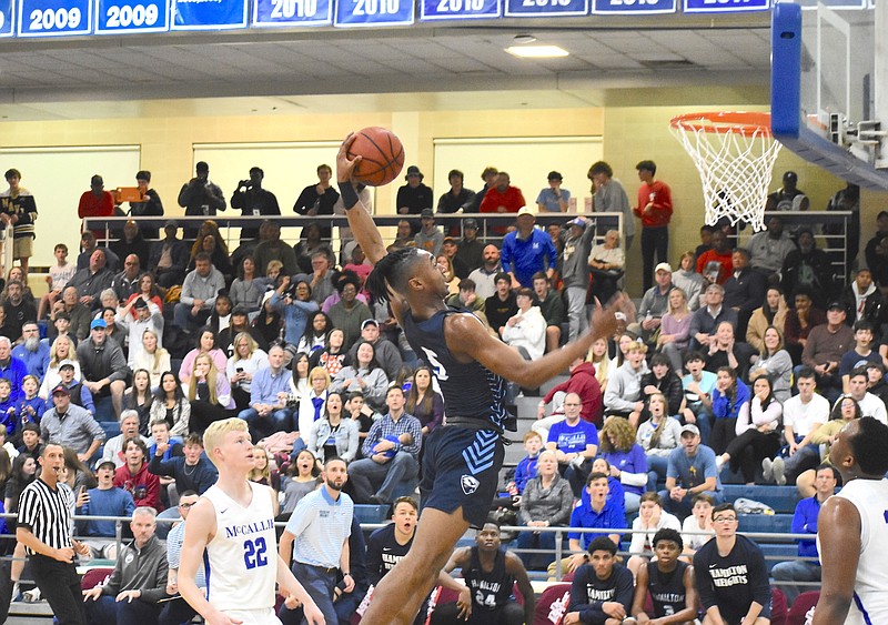 Hamilton Heights junior Drew Williams rises to the rim for a dunk in Saturday's Dr Pepper Classic win over host McCallie. / Staff photo by Patrick MacCoon