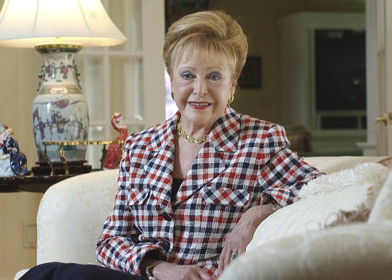 In this June 3, 2004 file photograph, author Mary Higgins Clark poses in her home in Saddle River, N.J. Clark, the tireless and long-reigning "Queen of Suspense" whose tales of women beating the odds made her one of the world's most popular writers, died Friday, Jan. 31, 2020, at age 92. Clark's publisher, Simon & Schuster, announced that Clark died in Naples, Fla, of natural causes. (AP Photo/Mike Derer, File)