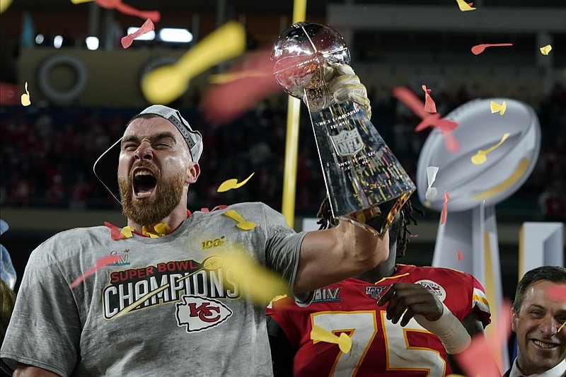 Kansas City Chiefs' Travis Kelce hoists the trophy after defeating the San Francisco 49ers in the NFL Super Bowl 54 football game Sunday, Feb. 2, 2020, in Miami Gardens, Fla. (AP Photo/David J. Phillip)