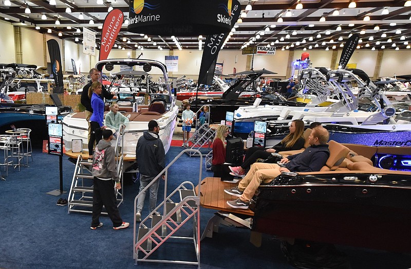 Staff File Photo by Tim Barber / Visitors at the 2019 Chattanooga Boat and Sport Show enjoy lounging on the deck of a MasterCraft boat. 
