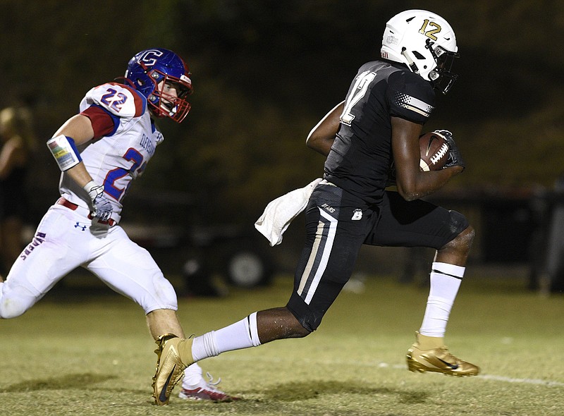 Bradley Central's Tray Curry outruns Cleveland's Parker Chastain for a touchdown. / Staff Photo by Robin Rudd