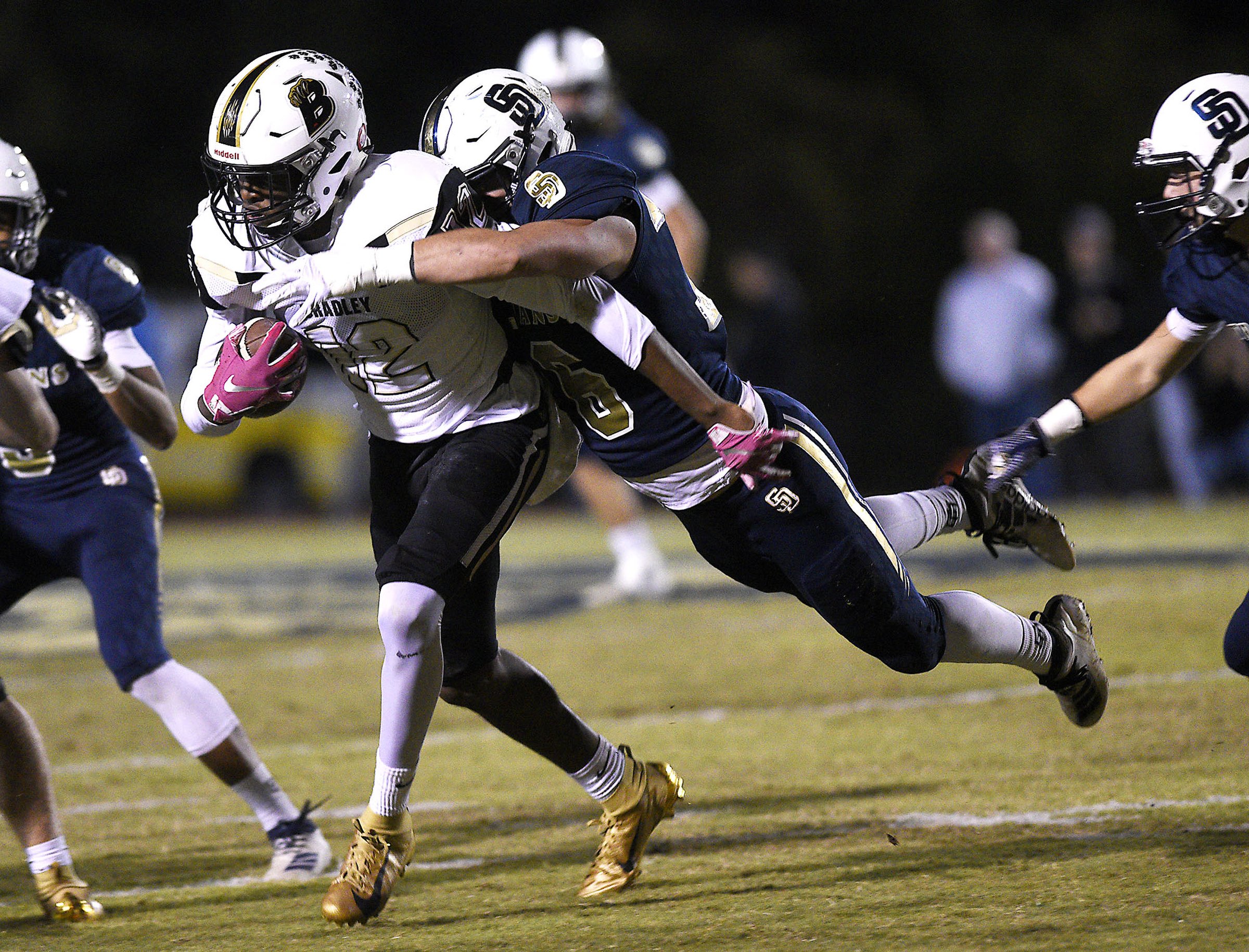 Staff Photo by Robin Rudd/ Bradley's Tray Curry (12) is brought down by Soddy-Daisy's Preston Begley (76). The Soddy-Daisy Trojans hosted the Bradley Central Bears in a TSSAA football game on October 24, 2019.