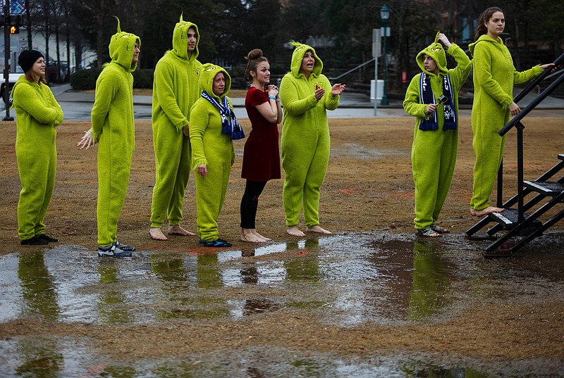 The Super EMTS to the Rescue team is dressed as characters from How the Grinch Stole Christmas as they wait near puddles to participate in the Special Olympics Polar Plunge at The Green at Ross's Landing on Saturday, Feb. 10, 2018, in Chattanooga, Tenn. Volunteers braved cold, rainy weather and plunged into an above-ground swimming pool at Chattanooga's riverfront to raise money for the Special Olympics. / Staff File Photo