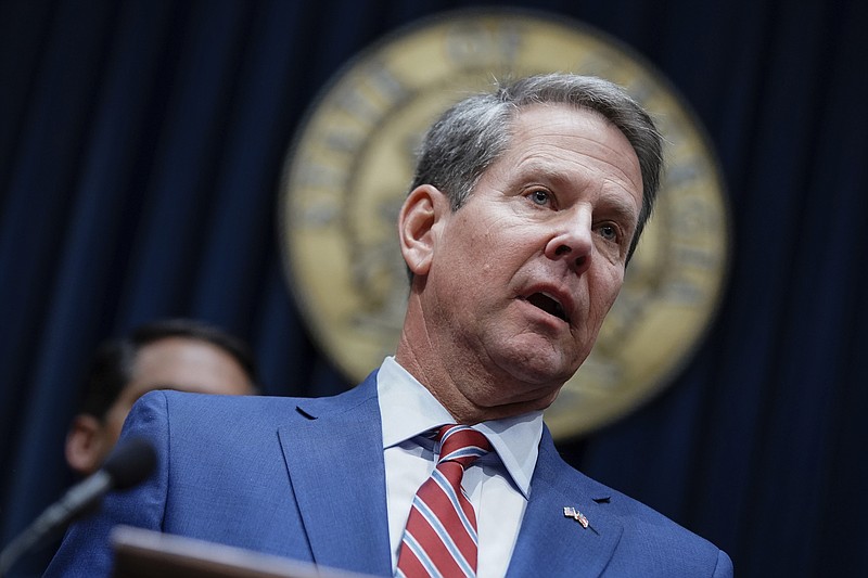 FILE - In this Dec. 4, 2019, file photo, Georgia Gov. Brian Kemp takes questions from the media at the Georgia state Capitol in Atlanta. Kemp and state Superintendent Richard Woods are announcing a plan Tuesday, Feb. 4, 2020, to cut five mandatory standardized tests for Georgia public school students, including four in high school. (AP Photo/Elijah Nouvelage, File)