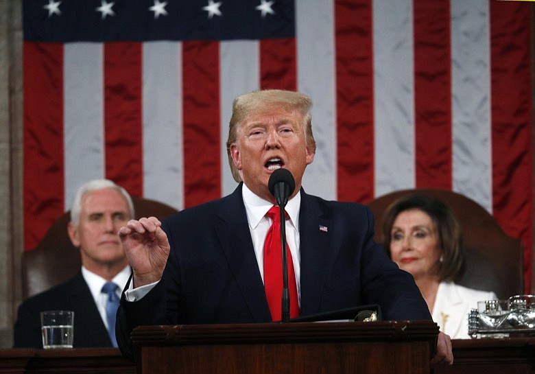 President Donald Trump delivers his State of the Union address to a joint session of Congress in the House Chamber on Capitol Hill in Washington, Tuesday, Feb. 4, 2020, as Vice President Mike Pence and Speaker Nancy Pelosi look on. (Leah Millis/Pool via AP)