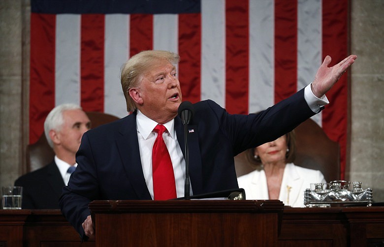 President Donald Trump delivers his State of the Union address to a joint session of Congress in the House Chamber on Capitol Hill in Washington, Tuesday, Feb. 4, 2020, as Vice President Mike Pence and Speaker Nancy Pelosi look on. (Leah Millis/Pool via AP)