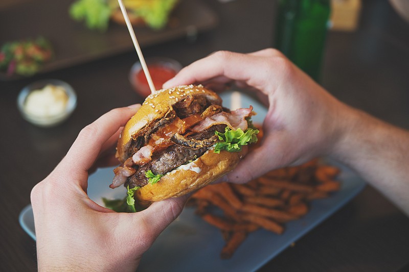 Eating a burger / Getty Images