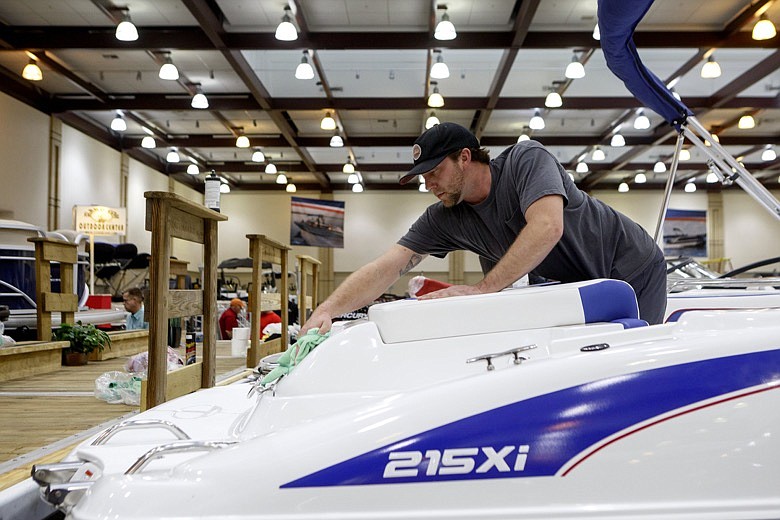 Johnathon George, with Island Cove Marina, works on cleaning a Tahoe 215 Xi while setting up for the 16th annual Chattanooga Boat and Sport Show at the Chattanooga Convention Center on Wednesday, Feb. 5, 2020, in Chattanooga, Tenn. The show opens Thursday from 3-9 p.m. It will continue on Friday from noon until 9 p.m., Saturday from 10 a.m. until 9 p.m. and Sunday from 11 a.m. until 5 p.m. Admission is $10 for adults and free for children 12 and under. / Staff photo by C.B. Schmelter