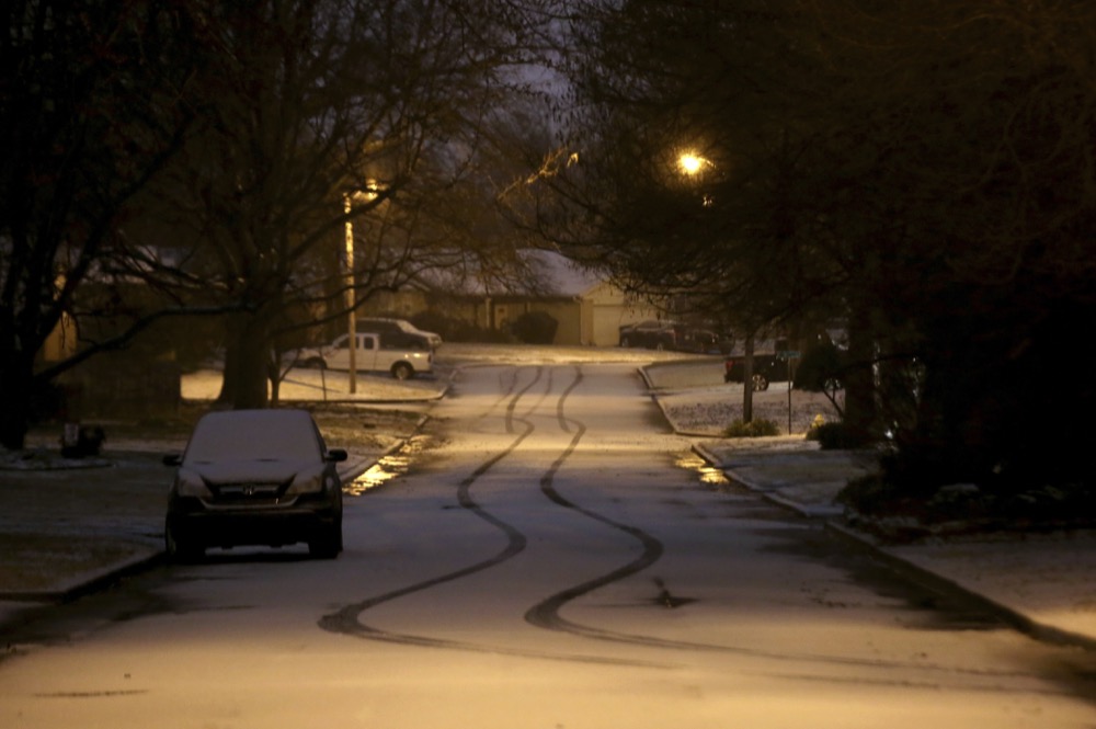 Snow covers the road in south Tulsa, Oka., on Wednesday, Feb. 5, 2020. A powerful winter storm dropped snow throughout parts of Texas and Oklahoma early Wednesday. (John Clanton/Tulsa World via AP)