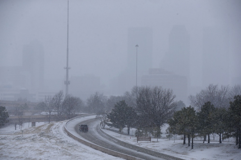 The downtown Tulsa skyline is barely visible with the snow falling in Tulsa, Okla., Wednesday, Feb. 5, 2020. (Stephen Pingry/Tulsa World via AP)