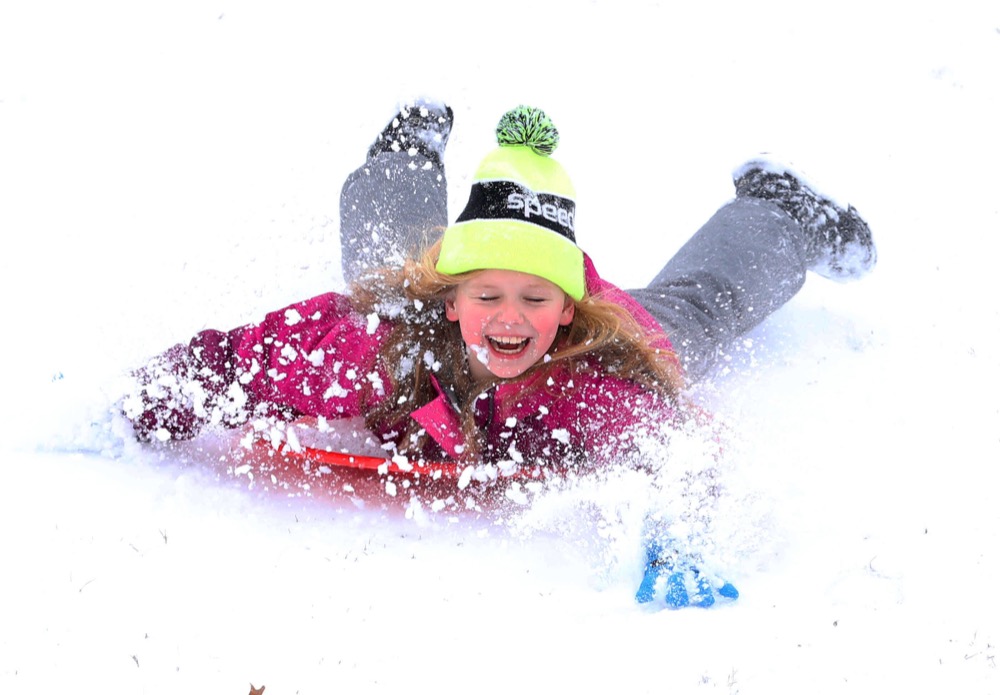 Alice Newhouse, 8, sleds down the snow covered hill next to Will Rogers High School in Tulsa on Wednesday, Feb. 5, 2020 after school was cancelled Wednesday due to a winter storm. . (Tom Gilbert/Tulsa World/Tulsa World via AP)
