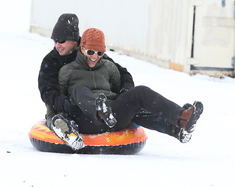 Chris Clendenin and Nancy Curry sled down the snow covered hill next to Will Rogers High School in Tulsa on Wednesday, Feb. 5, 2020. (Tom Gilbert/Tulsa World/Tulsa World via AP)