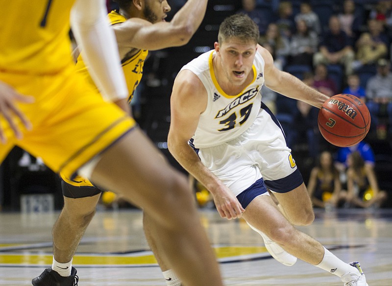 Staff photo by Troy Stolt / UTC senior guard Matt Ryan drives to the basket during an 80-64 home loss to ETSU on Wednesday.