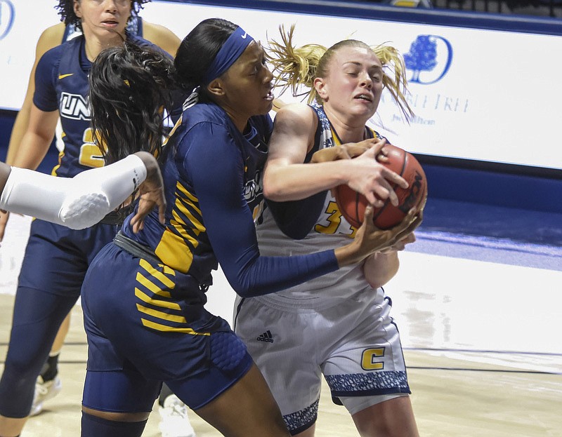 Staff photo by Tim Barber / UNC Greensboro's Aja Boyn, left, tries to take the ball from UTC guard Lakelyn Bouldin during Thursday night's SoCon matchup at McKenzie Arena. Bouldin scored 25 points to help the Mocs win 74-59.