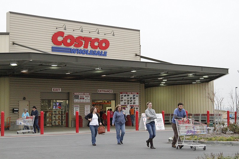 Staff photo by Alex Washburn/Chattanooga Times Free Press - December 20, 2011.Bryne, Lisa, Laura and Bo Lancaster leave Costco in Fort Oglethorpe Tuesday with dinner provisions.
