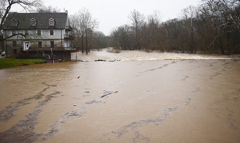 Staff Photo by Robin Rudd / The high water of South Chickamauga Creek breaks over the old dam that once served the Graysville Mill in Graysville, Georgia.  The home on the left is build on the site of the historic mill.  Heavy rain and flooding forced the closing of some local school systems on February 6, 2020.