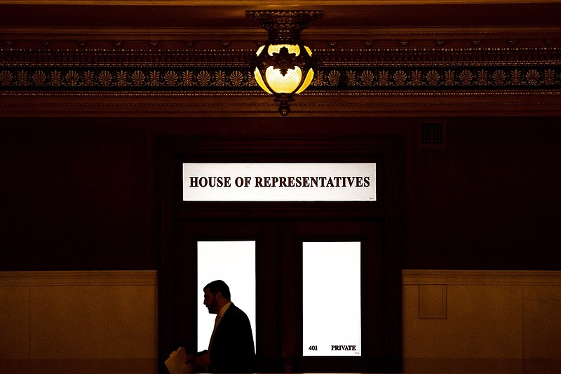 FILE - In this Nov. 20, 2019 file photo, a lawmaker is silhouetted as he walks past a window in the Pennsylvania Capitol in Harrisburg, Pa. (AP Photo/Matt Rourke, File)


