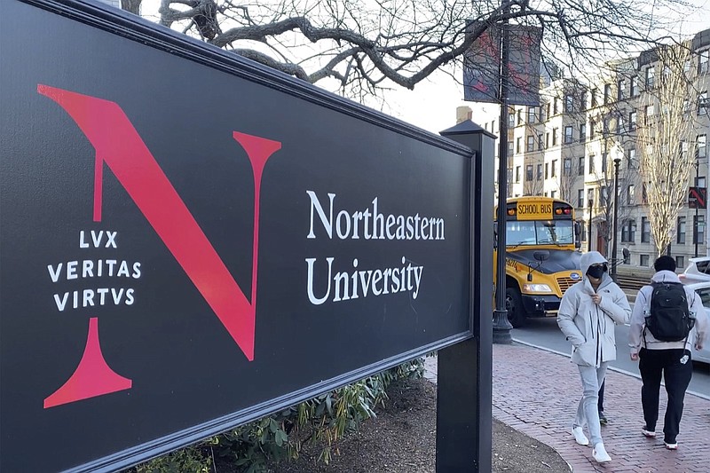 In this Jan. 31, 2019 photo, students walk on the Northeastern University campus in Boston. As concerns about China's virus outbreak spread, universities all over the world are scrambling to assess the risks to their programs. (AP Photo/Rodrique Ngowi)