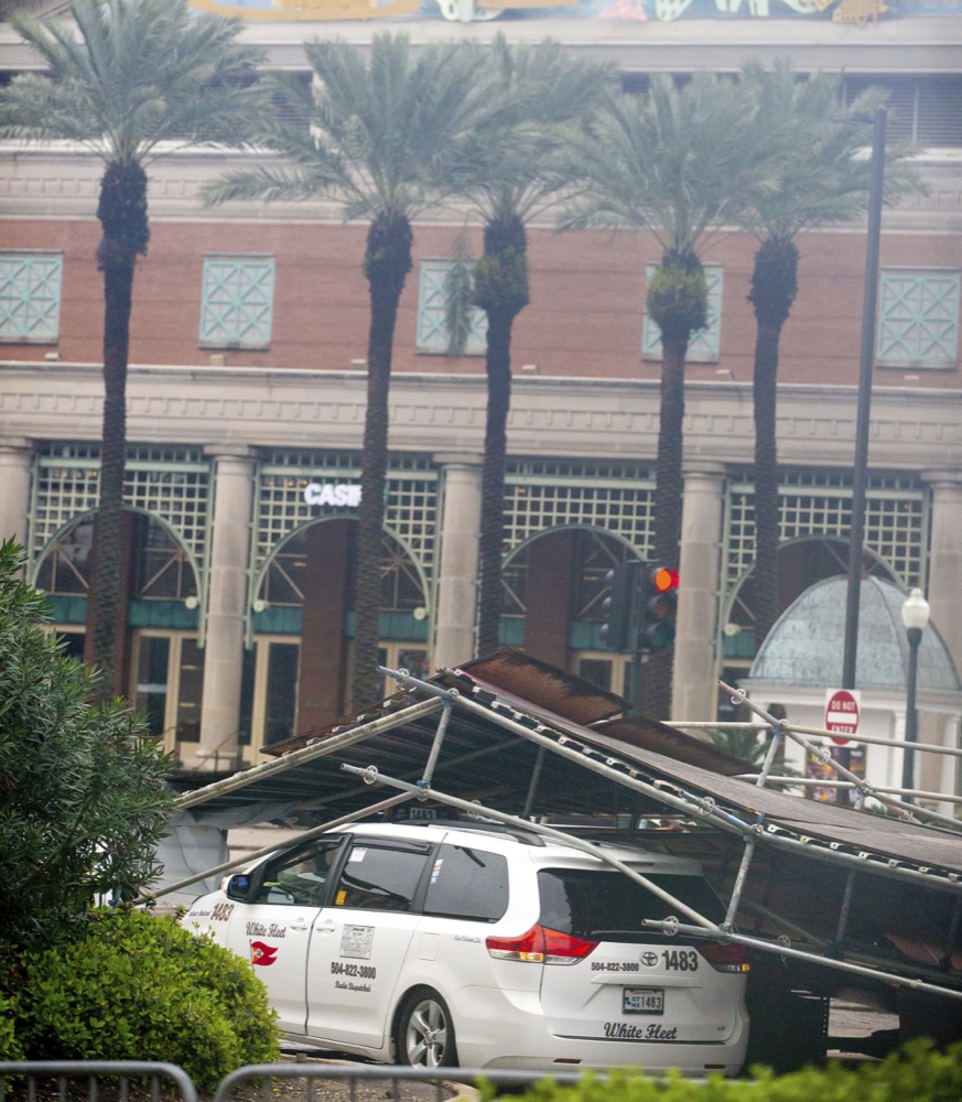 A portion of scaffolding is on top of cars at the former World Trade Center construction site after severe weather in New Orleans, La., Wednesday, Feb. 5, 2020. A section of scaffolding at the Four Seasons Hotel construction site in New Orleans collapsed onto at least a dozen cars Wednesday, leaving at least one person injured, as thunderstorms and high winds moved through the area. (Sophia Germer/The Advocate via AP)
