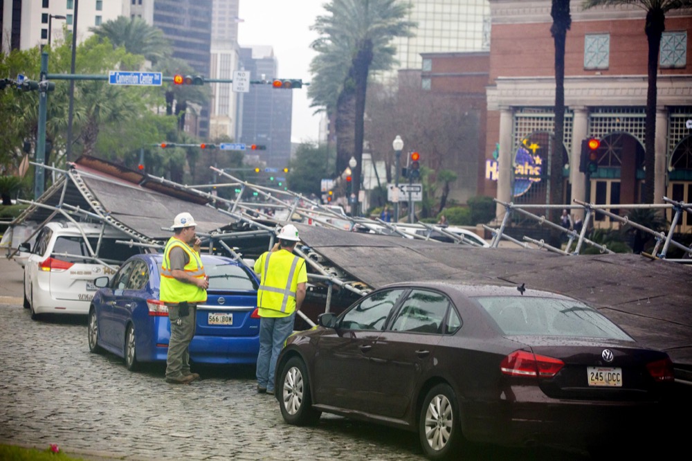 A portion of scaffolding is on top of cars at the former World Trade Center construction site after severe weather in New Orleans, La., Wednesday, Feb. 5, 2020. A section of scaffolding at the Four Seasons Hotel construction site in New Orleans collapsed onto at least a dozen cars Wednesday, leaving at least one person injured, as thunderstorms and high winds moved through the area. (Sophia Germer/The Advocate via AP)