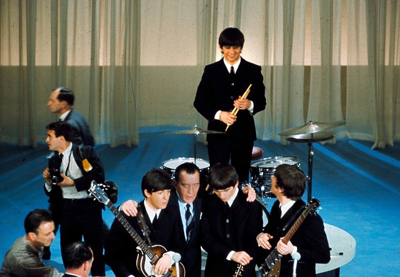 The British rock and roll group the Beatles are shown on stage with Ed Sullivan before their live television appearance on the The Ed Sullivan Show at CBS' Studio 50 in New York City, Feb. 9, 1964. From left are, Paul McCartney, Sullivan, George Harrison, Ringo Starr, standing, and John Lennon. (AP Photo)