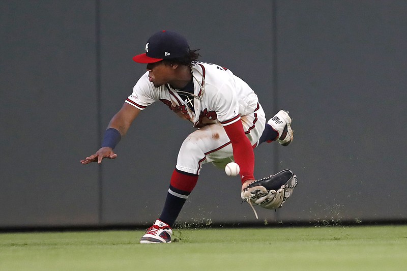 AP photo by John Bazemore / A ball hit for a double by the Toronto Blue Jays' Teoscar Hernandez gets past Atlanta Braves center fielder Ronald Acuna Jr. on Sept. 3, 2019, in Atlanta. Acuna hopes to help this year's Braves end the franchise's long run without a postseason series victory.