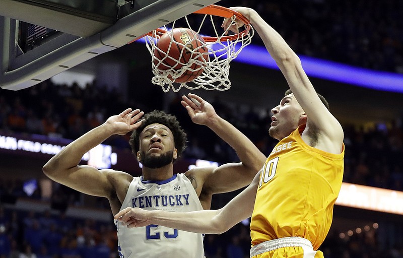 AP photo by Mark Humphrey / Tennessee forward John Fulkerson, right, dunks against Kentucky forward EJ Montgomery during an SEC tournament semifinal on March 16, 2019, in Nashville.