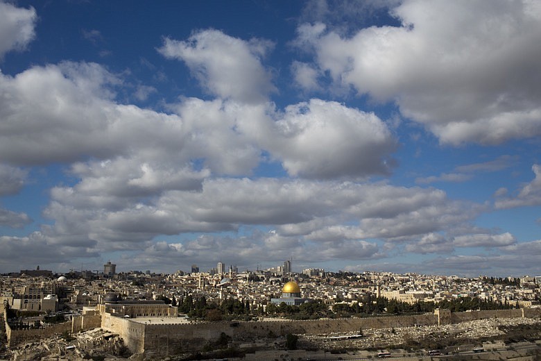 Clouds hang over Jerusalem's Old City, home to key holy sites for the world's three monotheistic religions, Thursday, Dec. 7, 2017. The densely packed area, less than one square kilometer (one-third of a square mile), hosts the Western Wall and the adjacent hilltop compound revered by Jews as the Temple Mount, the spot where the biblical Temples once stood and the holiest site in Judaism. (AP Photo/Ariel Schalit)