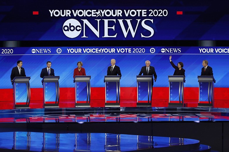 From left, Democratic presidential candidates entrepreneur Andrew Yang, former South Bend Mayor Pete Buttigieg, Sen. Bernie Sanders, I-Vt., former Vice President Joe Biden, Sen. Elizabeth Warren, D-Mass., Sen. Amy Klobuchar, D-Minn., and businessman Tom Steyer participate Friday, Feb. 7, 2020, in a Democratic presidential primary debate hosted by ABC News, Apple News, and WMUR-TV at Saint Anselm College in Manchester, N.H. (AP Photo/Elise Amendola)