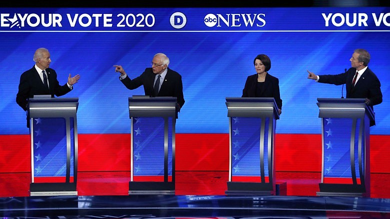 From left, Democratic presidential candidates former Vice President Joe Biden, Sen. Bernie Sanders, I-Vt., Sen. Amy Klobuchar, D-Minn., and businessman Tom Steyer participate in a Democratic presidential primary debate, Friday, Feb. 7, 2020, hosted by ABC News, Apple News, and WMUR-TV at Saint Anselm College in Manchester, N.H. (AP Photo/Elise Amendola)