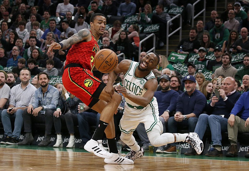 AP photo by Mary Schwalm / Boston Celtics guard Kemba Walker, right, reacts as he is fouled by Atlanta Hawks forward John Collins during the first half of Friday night's game in Boston.