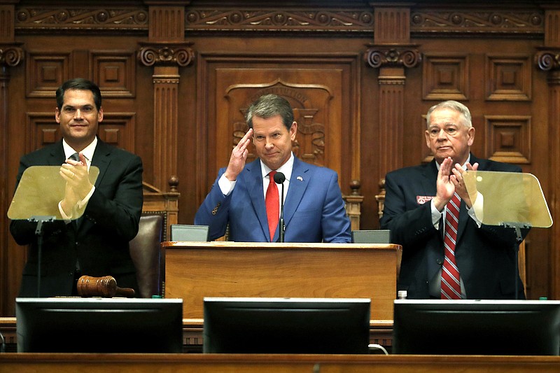 FILE - In this Jan. 16, 2020, file photo, Gov. Brian Kemp, center, is flanked by House Speaker David Ralston, R-Blue Ridge, right, and Lt. Gov. Geoff Duncan as he salutes former U.S. Senator Johnny Isakson, R-Ga., during the State of the State address before a joint session of the Georgia General Assembly in Atlanta. House Bill 757 passed Monday, Jan. 27, out of a House subcommittee. GOP Gov. Brian Kemp has threatened a veto. (AP Photo/John Bazemore, File)