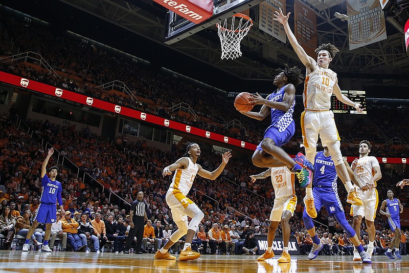 AP photo by Wade Payne / Kentucky guard Tyrese Maxey shoots a reverse layup as Tennessee forward John Fulkerson leaps to defend during the SEC rivals' matchup Saturday in Knoxville.