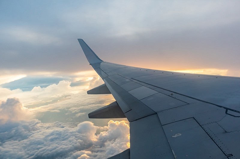 Airplane flying on the sky at sunset. plane tile airplane tile / Getty Images