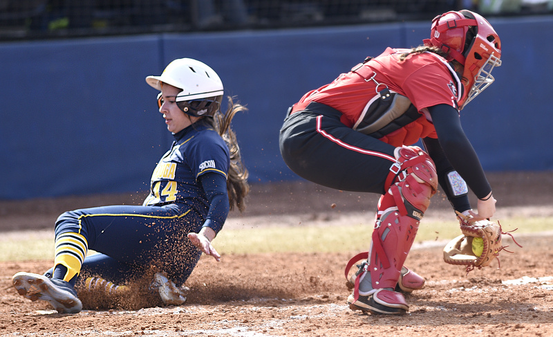 Staff Photo by Robin Rudd / UTC's Janessa Casanas (14) scores as she beats the tag of Peay catcher Kelsey Gray (1). The University of Tennessee at Chattanooga Mocs defeated the Austin Peay Governors in NCAA softball 9 to 1 in the first game at Jim Frost Stadium on February 9, 2020.