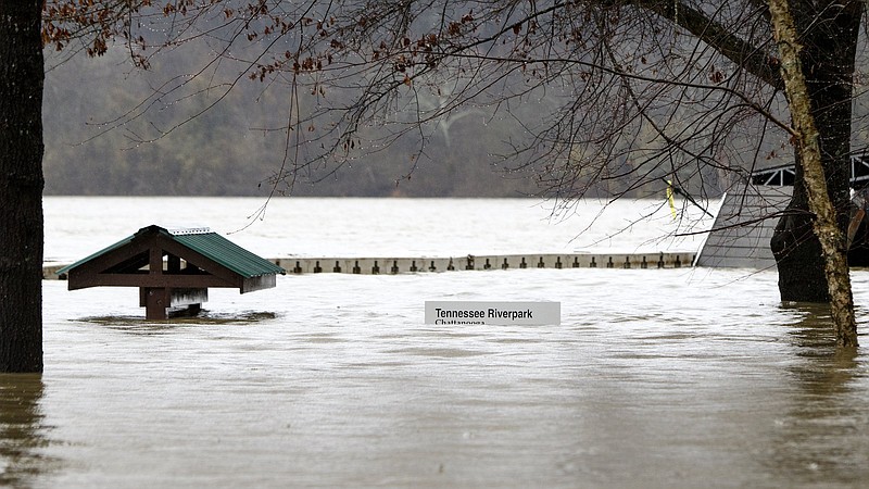 Staff photo by C.B. Schmelter / Flood waters cover signs at the Tennessee Riverpark on Monday, Feb. 10, 2020 in Chattanooga, Tenn.