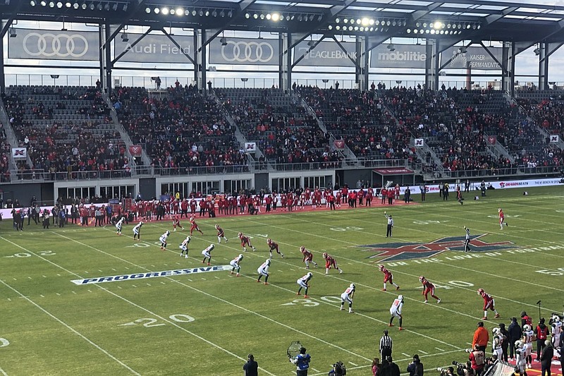 The D.C. Defenders, right, line up against the Seattle Dragons for the opening kickoff of the opening football game of the XFL season, Saturday, Feb. 8, 2020, in Washington, DC. (AP Photo/Stephen Whyno)