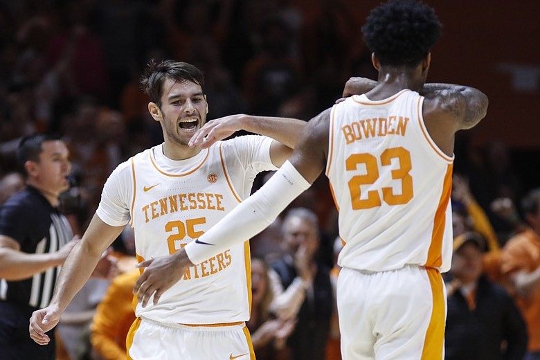 Tennessee guard Santiago Vescovi (25) celebrates hitting a three-point shot with guard Jordan Bowden (23) during an NCAA college basketball game against Kentucky Saturday, Feb. 8, 2020, in Knoxville, Tenn. Kentucky won 77-64. (AP Photo/Wade Payne)