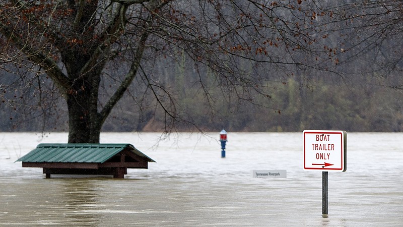 Staff photo by C.B. Schmelter / Flood waters cover signs at the Tennessee Riverpark on Monday, Feb. 10, 2020 in Chattanooga, Tenn.
