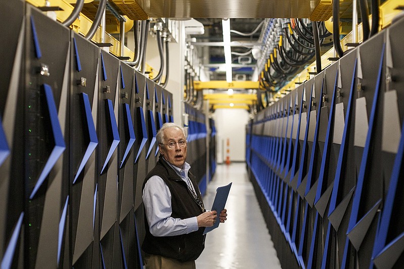 Staff photo by C.B. Schmelter / Oak Ridge National Laboratory National Center for Computational Sciences Director James Hack tours the Summit supercomputer on the campus of ORNL on Monday, June 10, 2019 in Oak Ridge, Tenn. The Summit is currently the fastest computer in the world.
